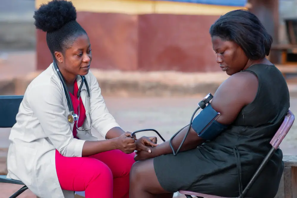 African humanitarian aid doctor caring for a patient, emphasizing client empowerment. 