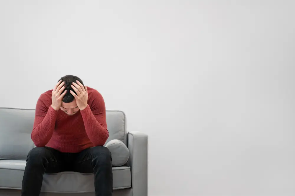 Photo of a man sitting on a chair, conveying the experience of someone grappling with mental illness and seeking support.