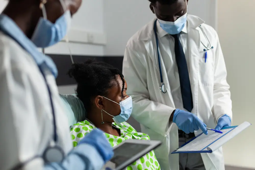 Young African American patient in bed, wearing a protective face mask during a Quality Assurance assessment.