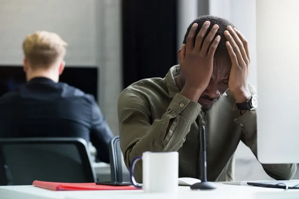 Image illustrating the impact of Loss of Awareness on daily activities, with one person in distress and another using a laptop.