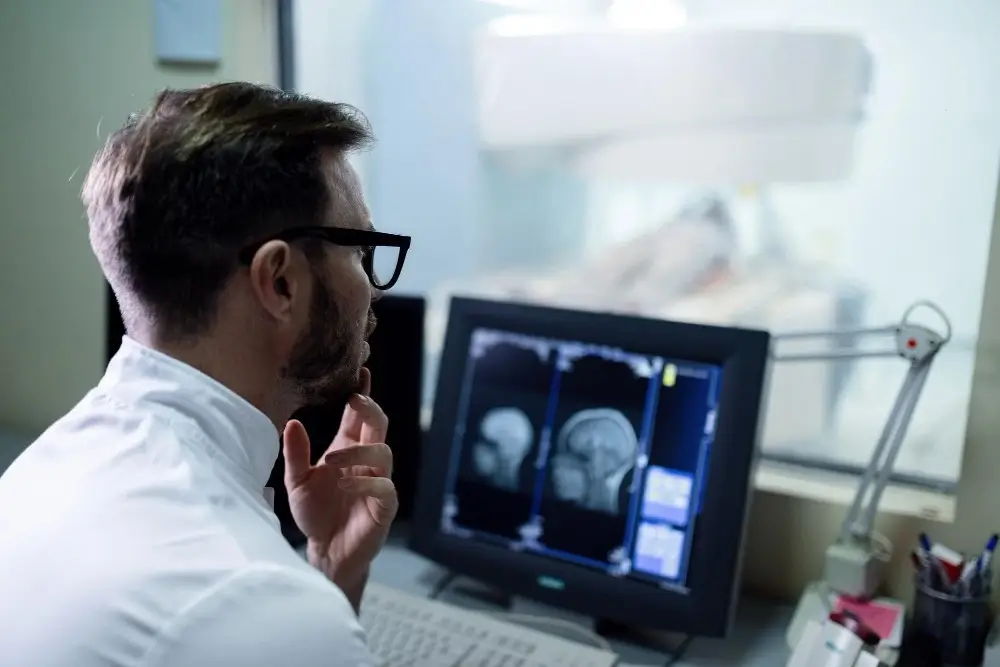 Medical professionals examining brain scans to diagnose and assess brain tumors for accurate medical treatment.